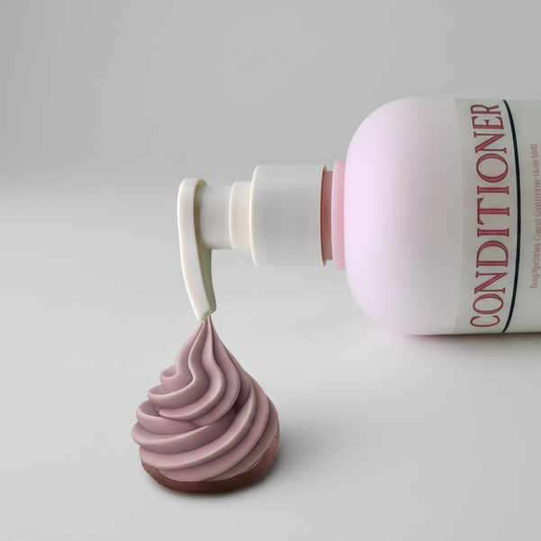 Bottle of conditioner with a pump and a sample of purple conditioner on a grey background